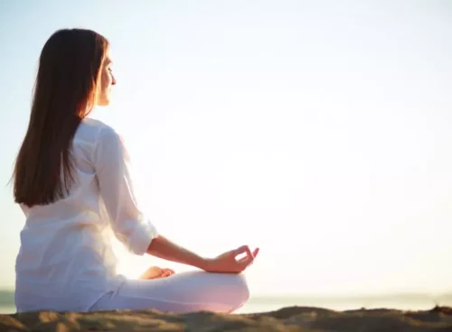6 Powerful Exercises for Anxiety Relief and Relaxation woman sitting yoga pose beach 800x533 1